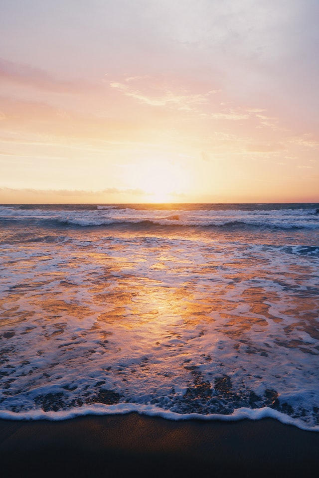 photo-of-ocean-waves-near-seashore-during-sunset-982673